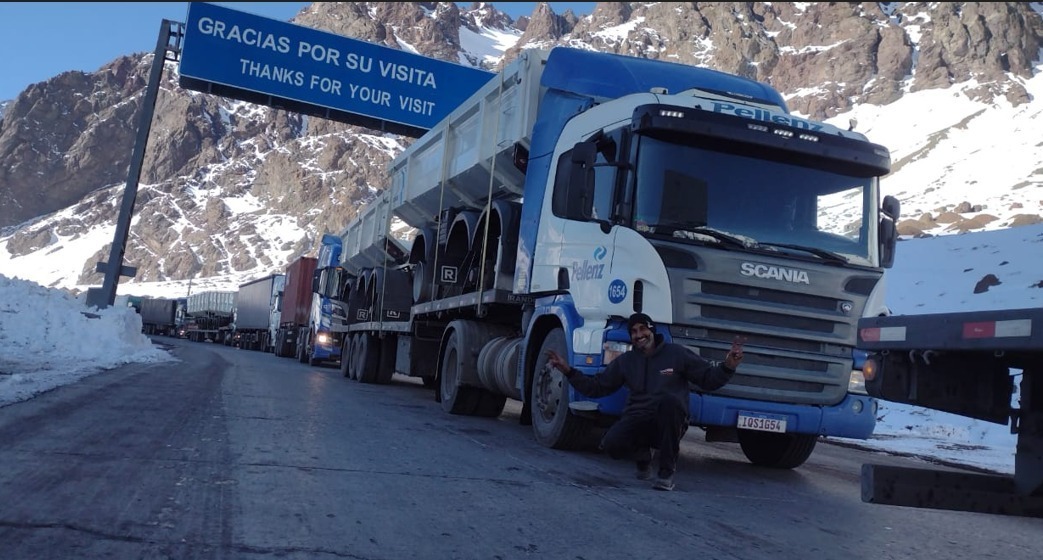 Motorista da Pellenz em frente ao caminhão, representando os profissionais que movimentam o transporte rodoviário brasileiro.